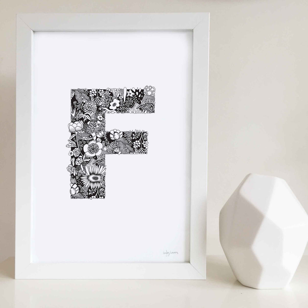 The floral letter 'F' artwork was illustrated by Hayley Lauren in Melbourne, Australia. It is the perfect artwork to personalise a nursery or kids bedroom.