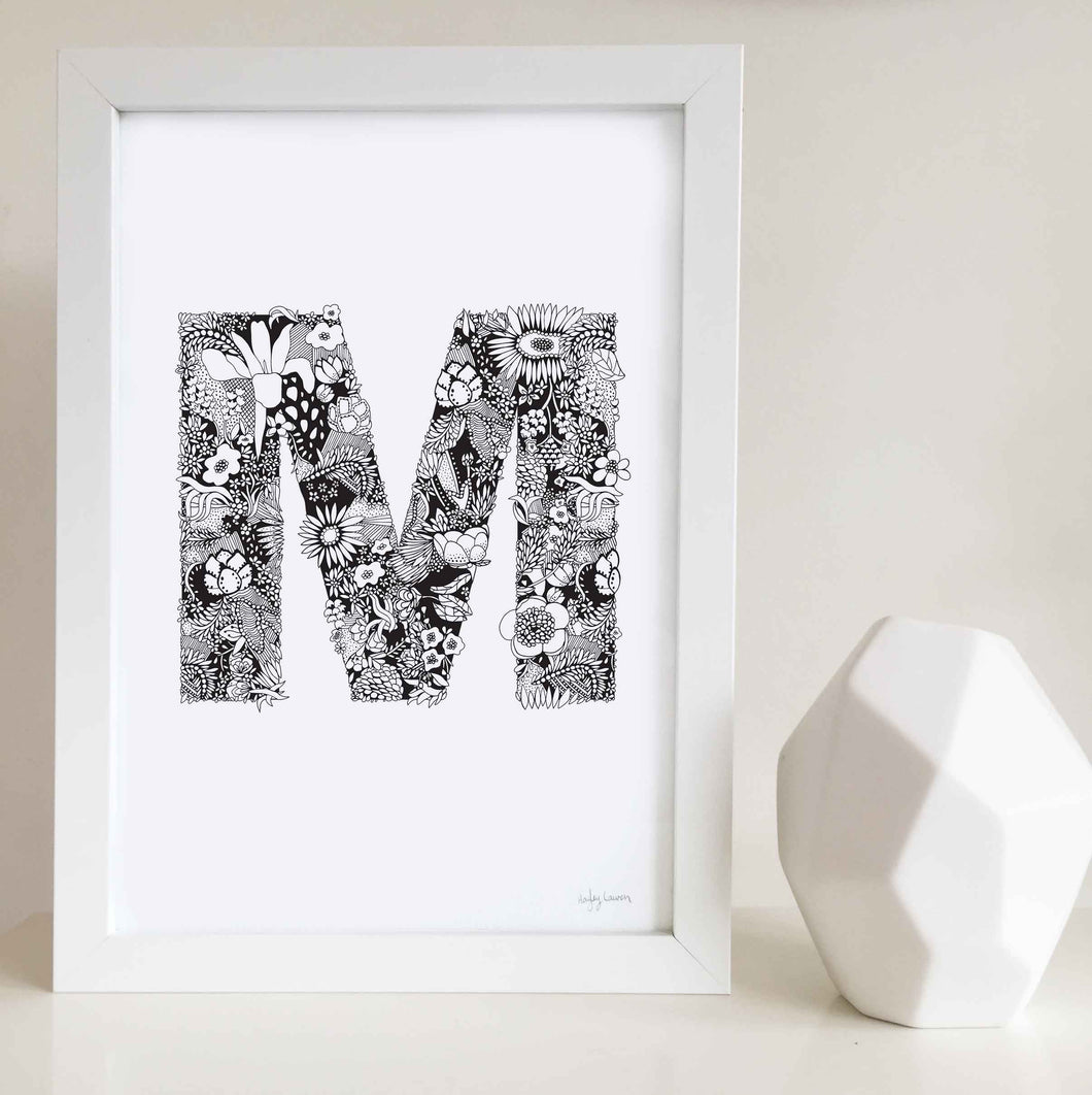 The floral letter 'M' artwork was illustrated by Hayley Lauren in Melbourne, Australia. It is the perfect artwork to personalise a nursery or kids bedroom.