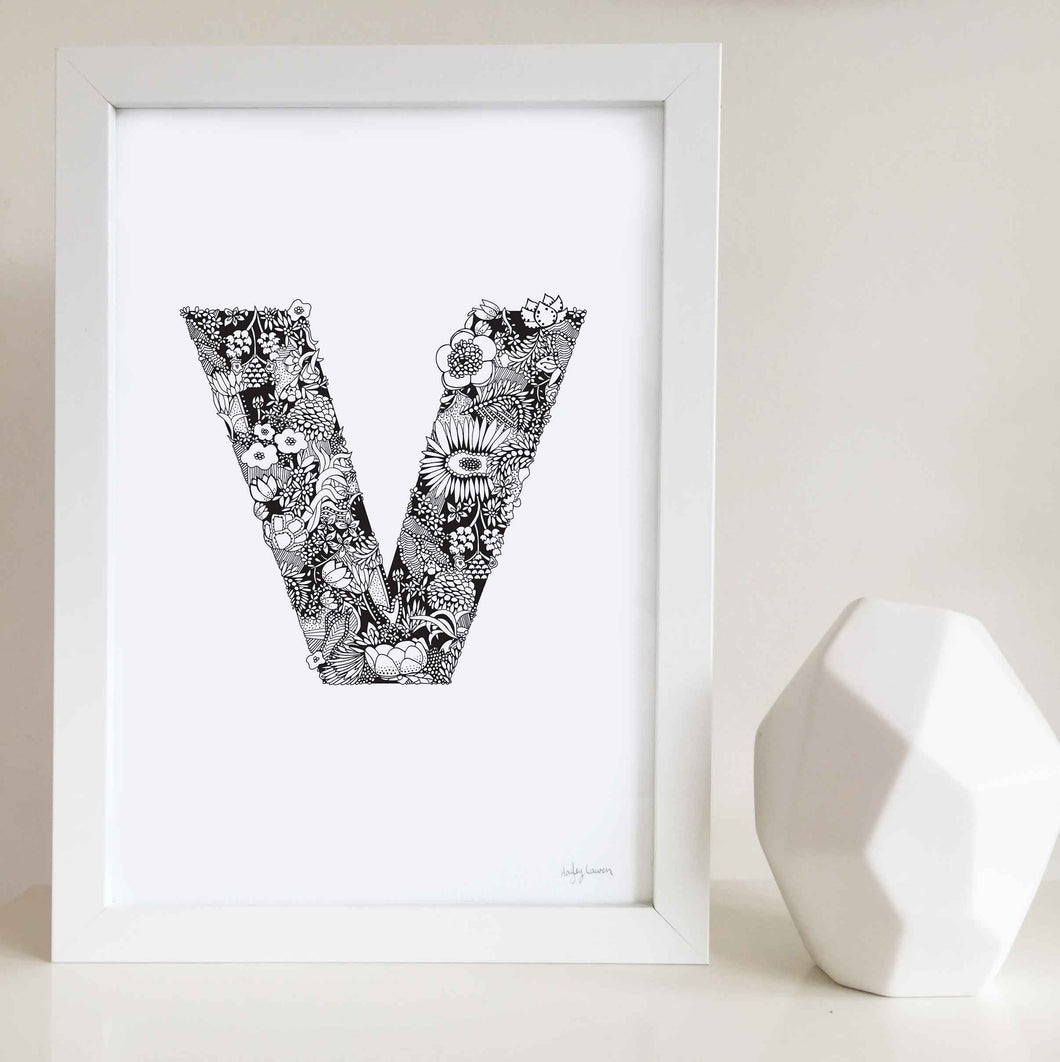 The floral letter 'V' artwork was illustrated by Hayley Lauren in Melbourne, Australia. It is the perfect artwork to personalise a nursery or kids bedroom.