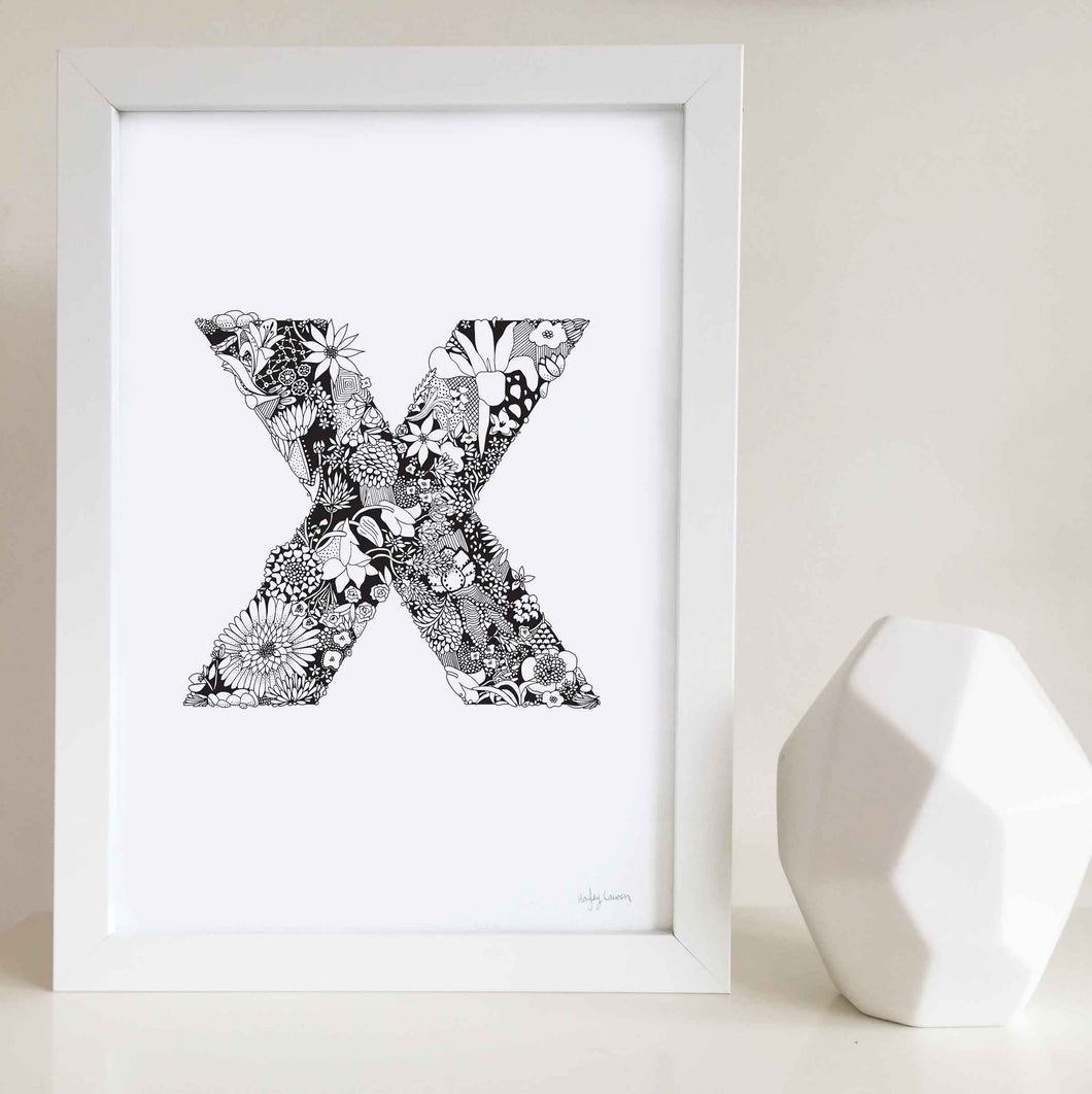 The floral letter 'X' artwork was illustrated by Hayley Lauren in Melbourne, Australia. It is the perfect artwork to personalise a nursery or kids bedroom.