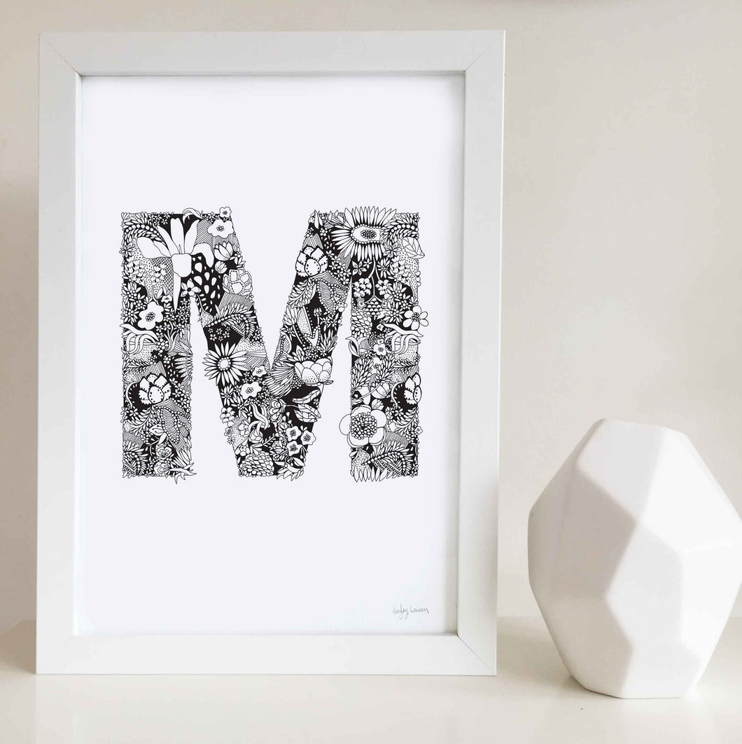 The floral letter 'M' artwork was illustrated by Hayley Lauren in Melbourne, Australia. It is the perfect artwork to personalise a nursery or kids bedroom. 